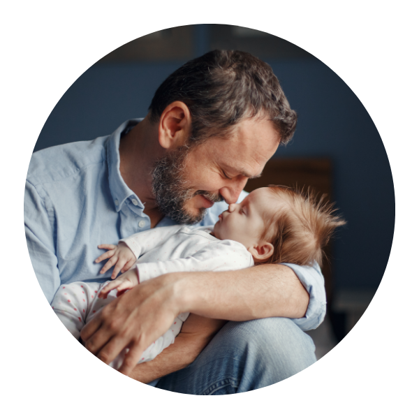 Father holding baby with seizures, searching for genetic insights.